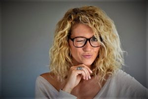 Portrait of blond woman with eyeglasses being expressive 1