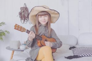 kid-girl-in-hat-playing-ukulele-at-home-9BLWFJN-scaled.jpg 3
